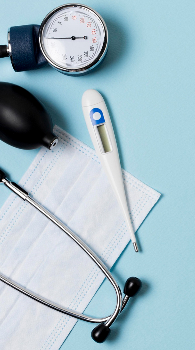 A digital thermometer, a stethoscope, a disposable face mask, and a blood pressure cuff are arranged on a light blue background.